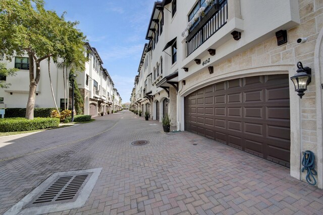 garage featuring decorative driveway