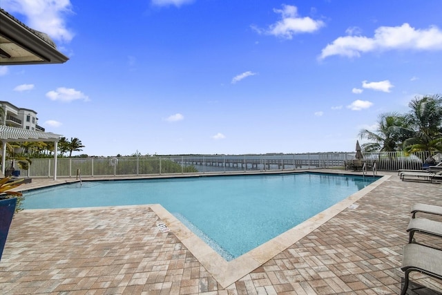 pool featuring fence and a patio