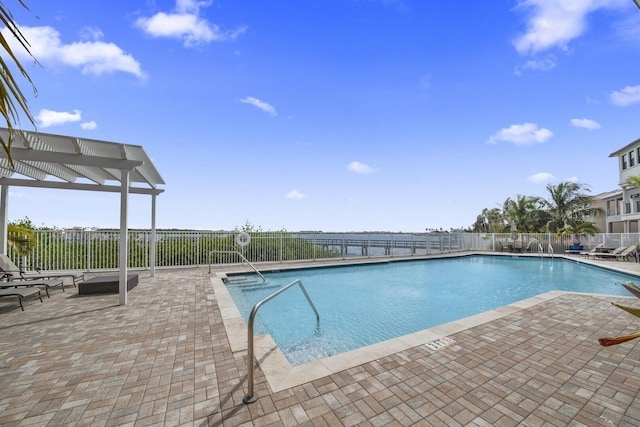 community pool featuring fence, a pergola, and a patio