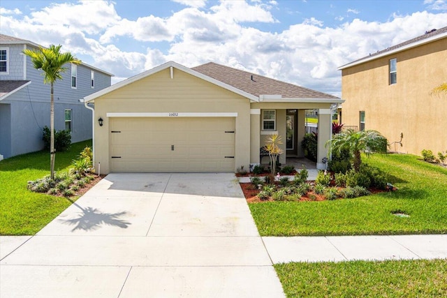 view of front of house featuring a garage and a front lawn