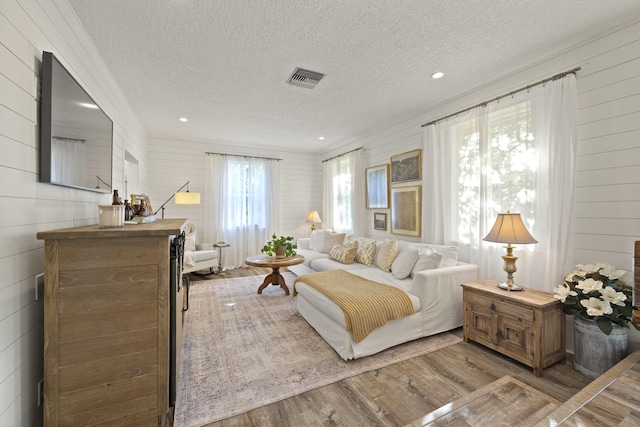 interior space featuring a textured ceiling and light wood-type flooring