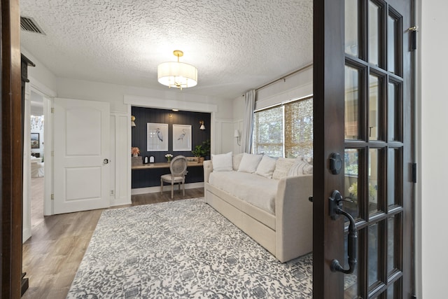 living room featuring hardwood / wood-style flooring and a textured ceiling