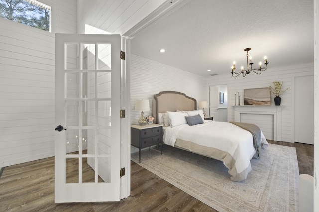 bedroom featuring dark hardwood / wood-style floors, a chandelier, and a textured ceiling