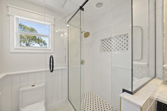 bathroom with walk in shower, vanity, and toilet