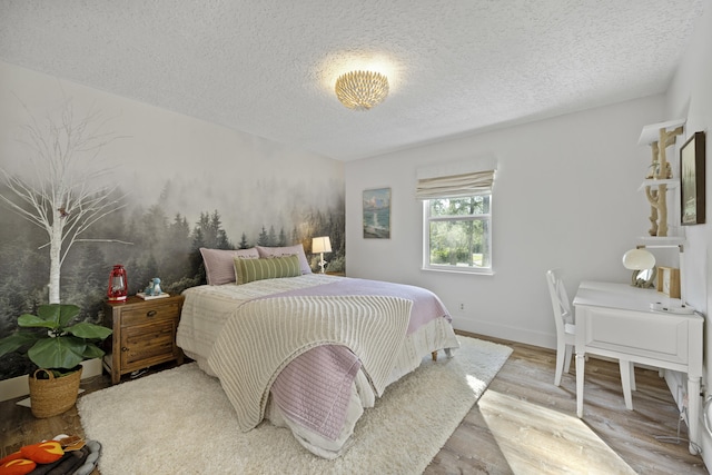 bedroom with wood-type flooring and a textured ceiling