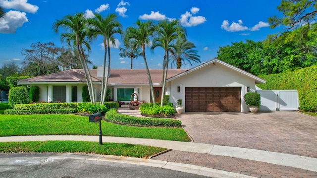 ranch-style house with a garage and a front yard