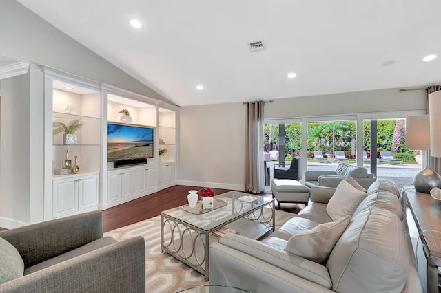 living room featuring light hardwood / wood-style floors, vaulted ceiling, and built in features