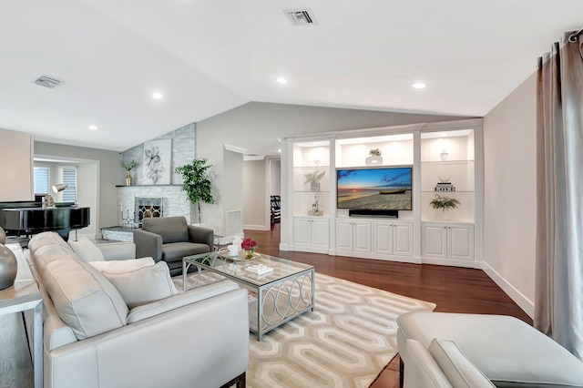 living room with a fireplace, dark hardwood / wood-style floors, and vaulted ceiling