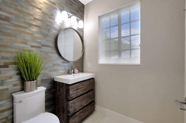 bathroom with vanity, tile patterned flooring, and toilet