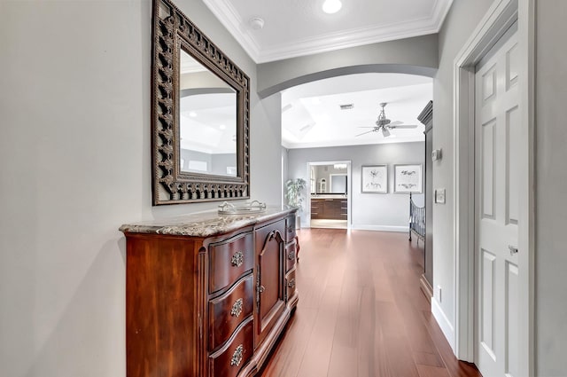 corridor featuring ornamental molding and dark hardwood / wood-style floors