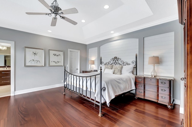 bedroom with dark hardwood / wood-style floors, a raised ceiling, and ceiling fan