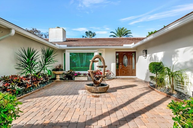 property entrance featuring a patio