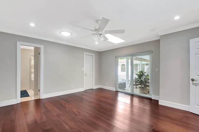 empty room with dark hardwood / wood-style flooring, ornamental molding, and ceiling fan