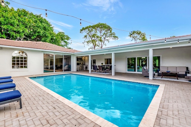 view of swimming pool with an outdoor living space and a patio area