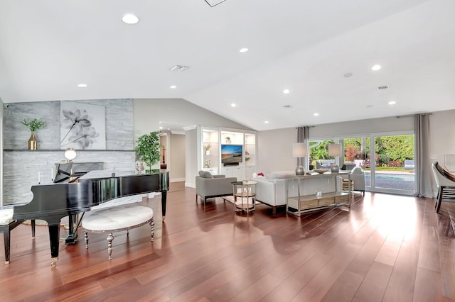 living room featuring lofted ceiling and hardwood / wood-style floors