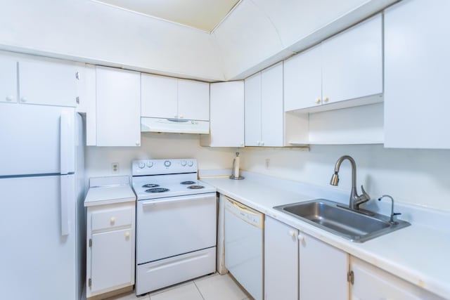 kitchen featuring white appliances, light tile patterned floors, sink, and white cabinets