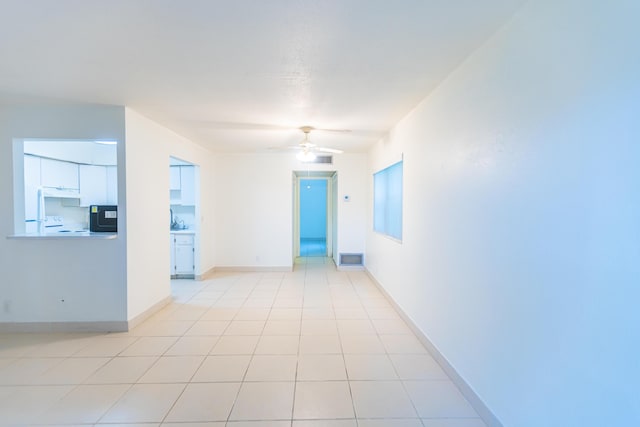 tiled empty room with ceiling fan