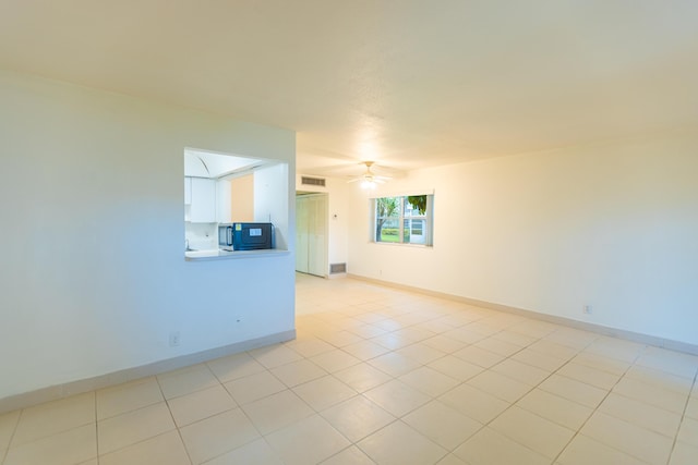 empty room featuring ceiling fan and light tile patterned floors