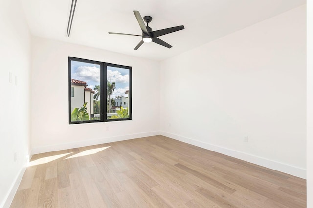 spare room with light hardwood / wood-style floors and ceiling fan