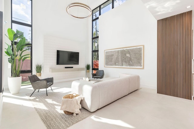 living room featuring a high ceiling and a wall of windows