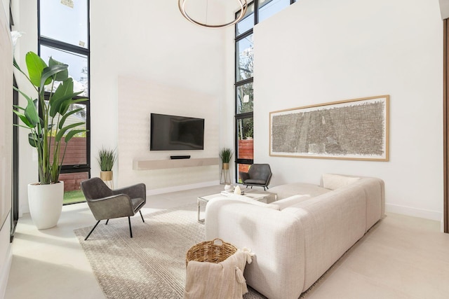 living room with a wall of windows, plenty of natural light, and a high ceiling