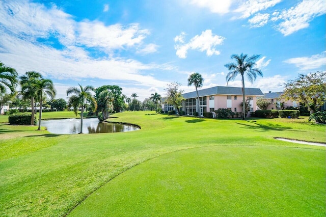 view of community with a yard and a water view