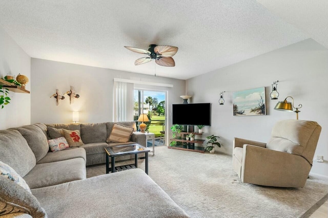 living room with light carpet, a textured ceiling, and a ceiling fan