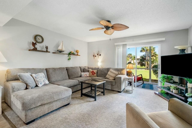 living area with a textured ceiling and a ceiling fan