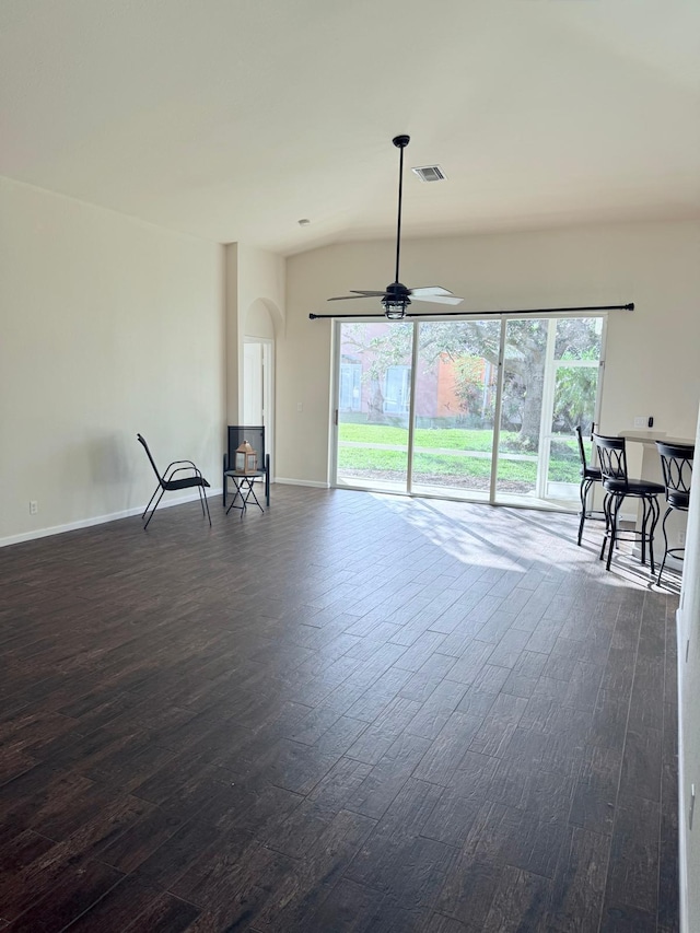 living room with ceiling fan, plenty of natural light, and dark hardwood / wood-style flooring