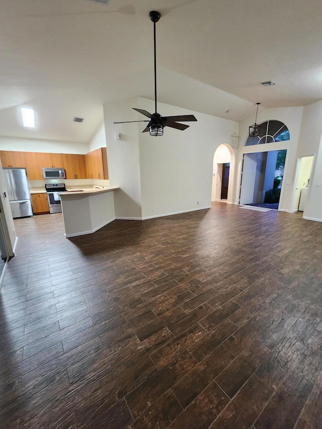 unfurnished living room with high vaulted ceiling, dark wood-type flooring, and ceiling fan