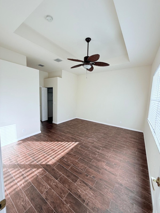 interior space featuring a tray ceiling and ceiling fan