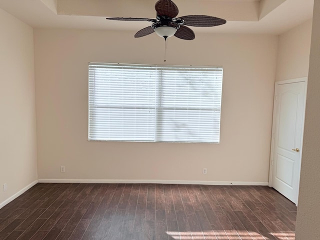 unfurnished room with ceiling fan, a healthy amount of sunlight, and dark hardwood / wood-style flooring