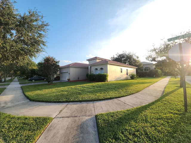 view of side of home featuring a garage and a lawn