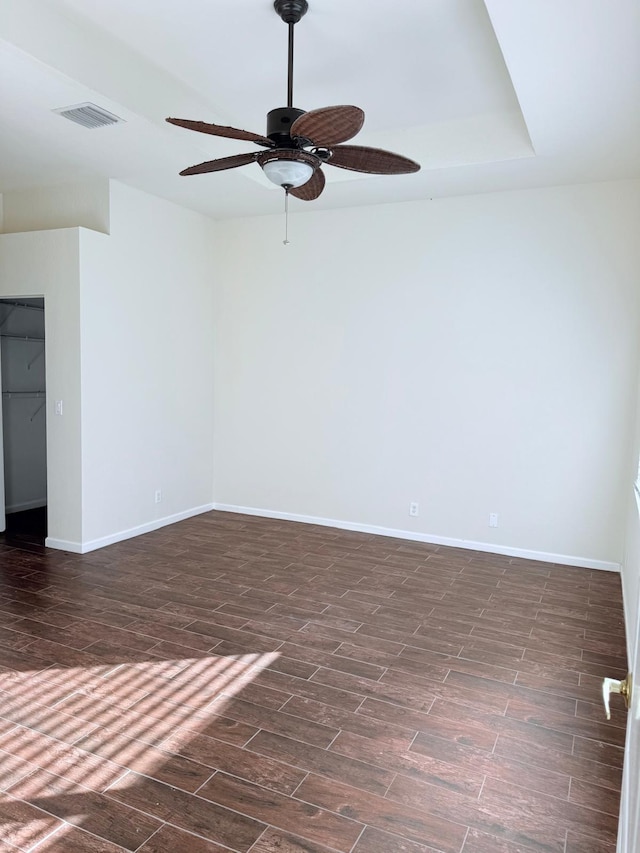 empty room featuring dark hardwood / wood-style floors and ceiling fan