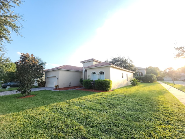 view of side of home featuring a garage and a lawn