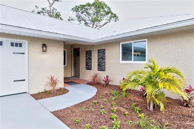 view of exterior entry featuring a garage