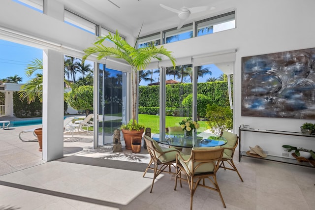 sunroom featuring ceiling fan