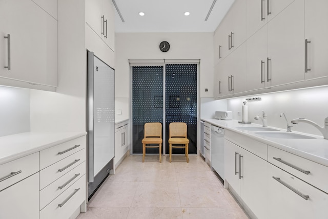 kitchen featuring light tile patterned flooring, white appliances, sink, and white cabinets