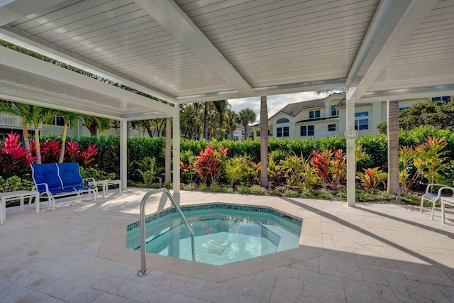 view of swimming pool featuring an in ground hot tub and a patio area