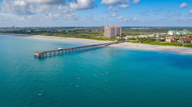 birds eye view of property with a water view and a beach view