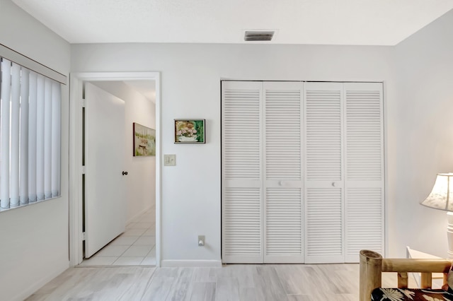 bedroom featuring light hardwood / wood-style flooring and a closet