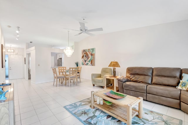 living room featuring vaulted ceiling, ceiling fan with notable chandelier, and light tile patterned floors