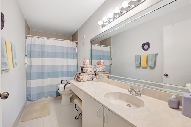 bathroom with walk in shower, vanity, and toilet