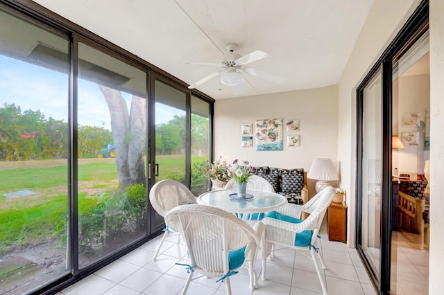 sunroom featuring ceiling fan