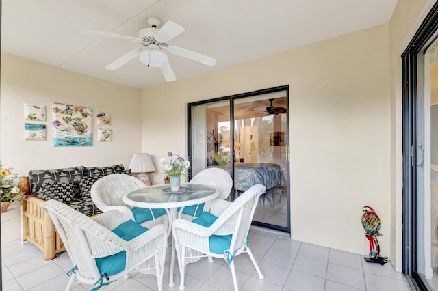 tiled dining space with ceiling fan