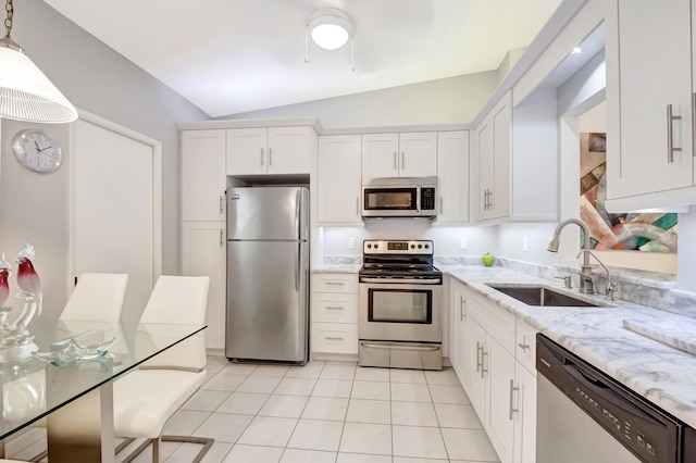 kitchen with sink, hanging light fixtures, appliances with stainless steel finishes, light stone countertops, and white cabinets