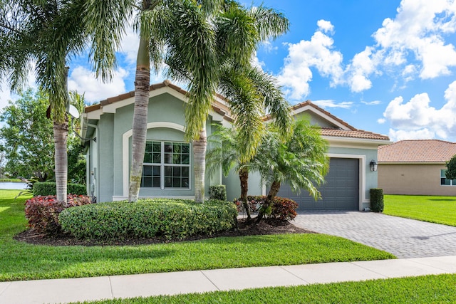 view of front of home with a garage and a front lawn