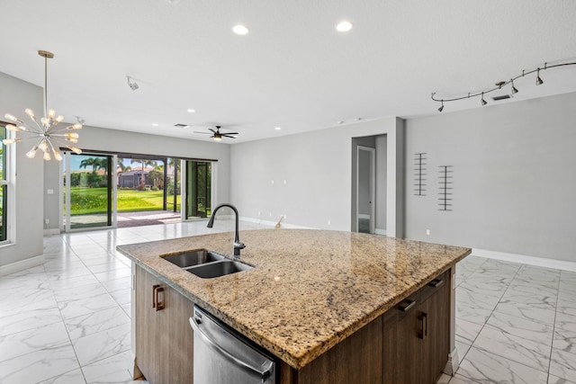 kitchen with pendant lighting, dishwasher, sink, light stone counters, and a center island with sink