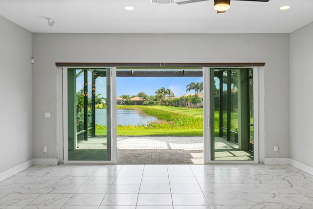 doorway to outside featuring a water view and ceiling fan