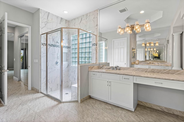 bathroom featuring walk in shower, plenty of natural light, vanity, and ornate columns